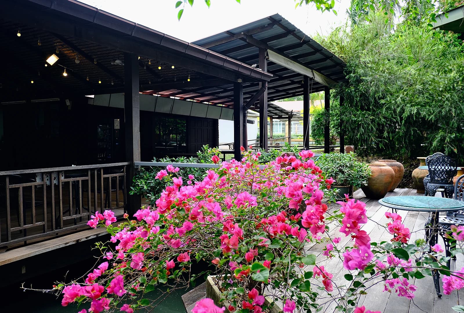 Shaded outdoor restaurant patio with bistro seating