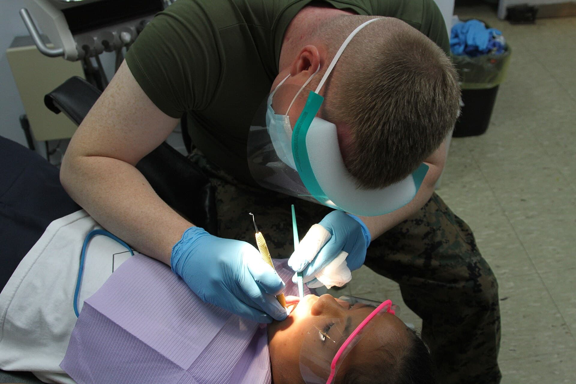 Pediatric dentist examining a young child's teeth, finding the best kids dentist in Dallas